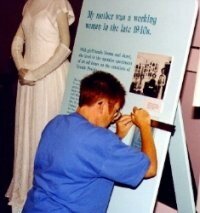 Louise Mcleod working on a text panel.