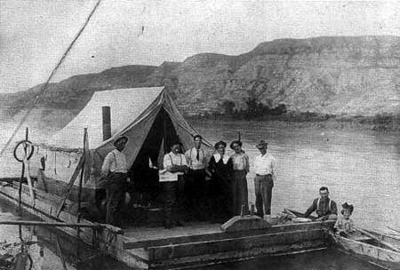 Palaeontologist Barnum Brown's scow on the Red Deer River in Dinosaur Provincial Park (c.1912): (l to r) George Olson and Peter Kaisen from the American Museum of Natural History; second from far right (seated), George Sternberg. Others in the photo are unidentified. Credit: American Museum of Natural History.